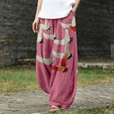 Noémie – Pantalon large rose à motif de grues
