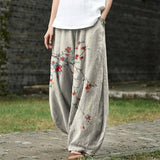 Denise – Pantalon large beige à motif de feuilles rouges